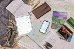Travel planning map with camera, compass, passport and notebook