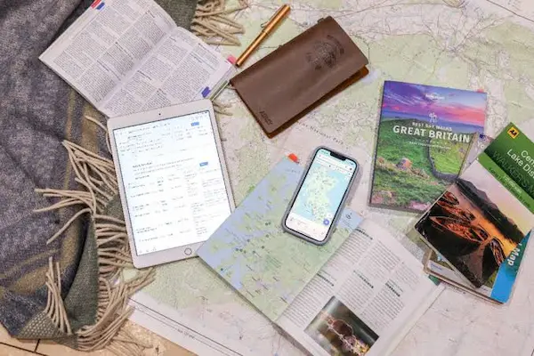 Travel planning map with camera, compass, passport and notebook