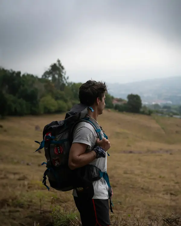 Pilgrim walking a countryside pilgrimage route with backpack