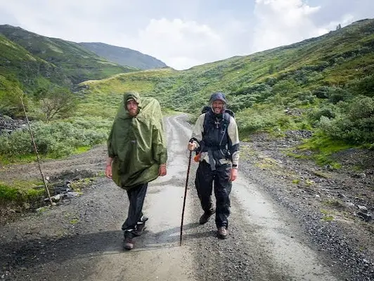 Two pilgrims walking along a mountain pilgrimage route